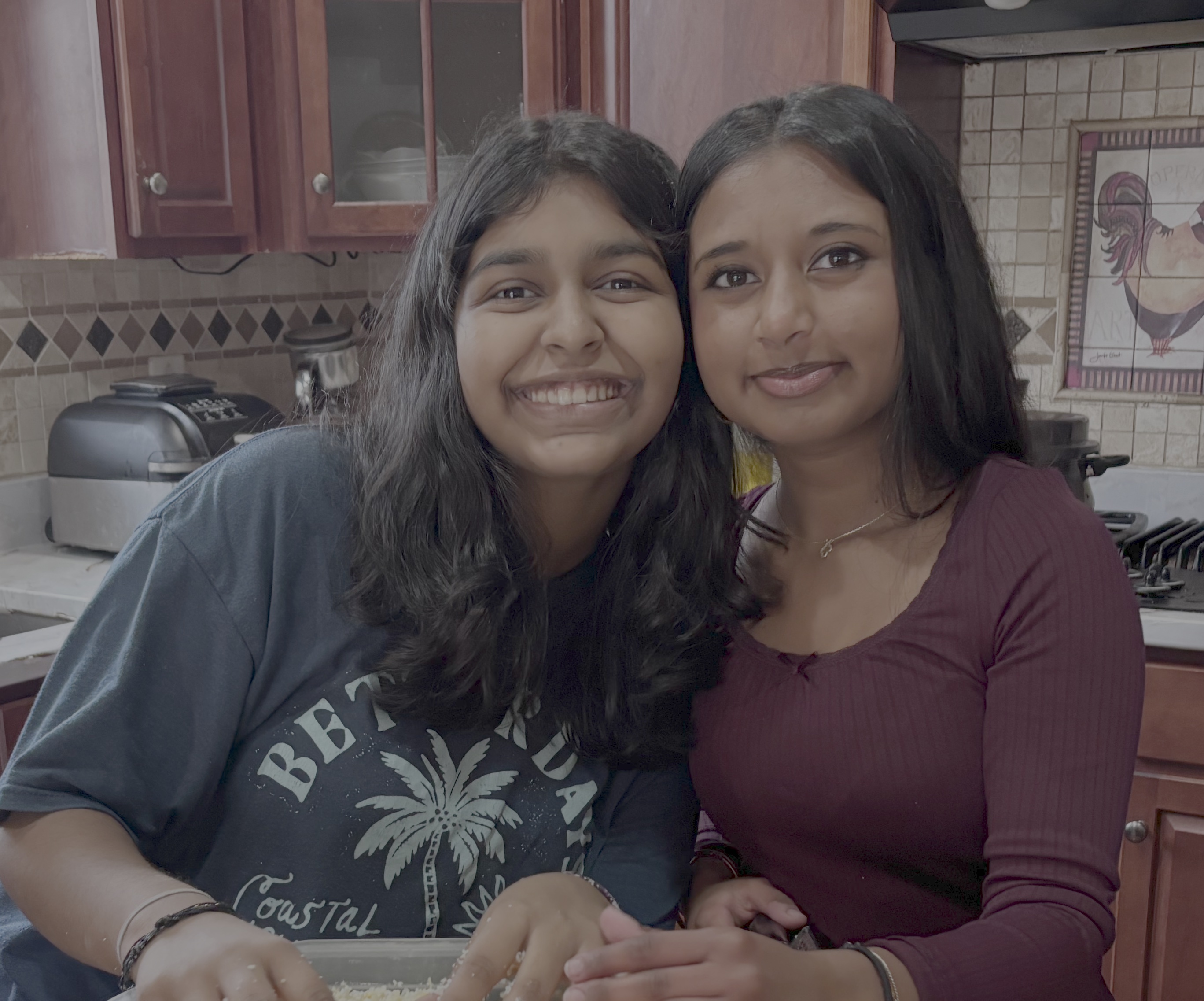 Titiksha and Ashu smiling together while preparing for a Speranza Cause fundraiser.